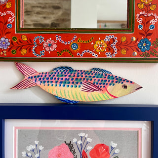 Colourful mackerel fish decoration by Lee Foster-Wilson displayed between colourful frames